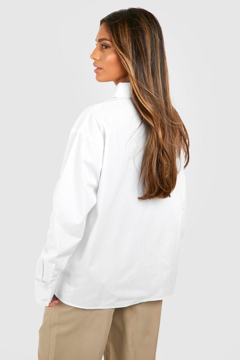 Біла велика сорочка з кишенями